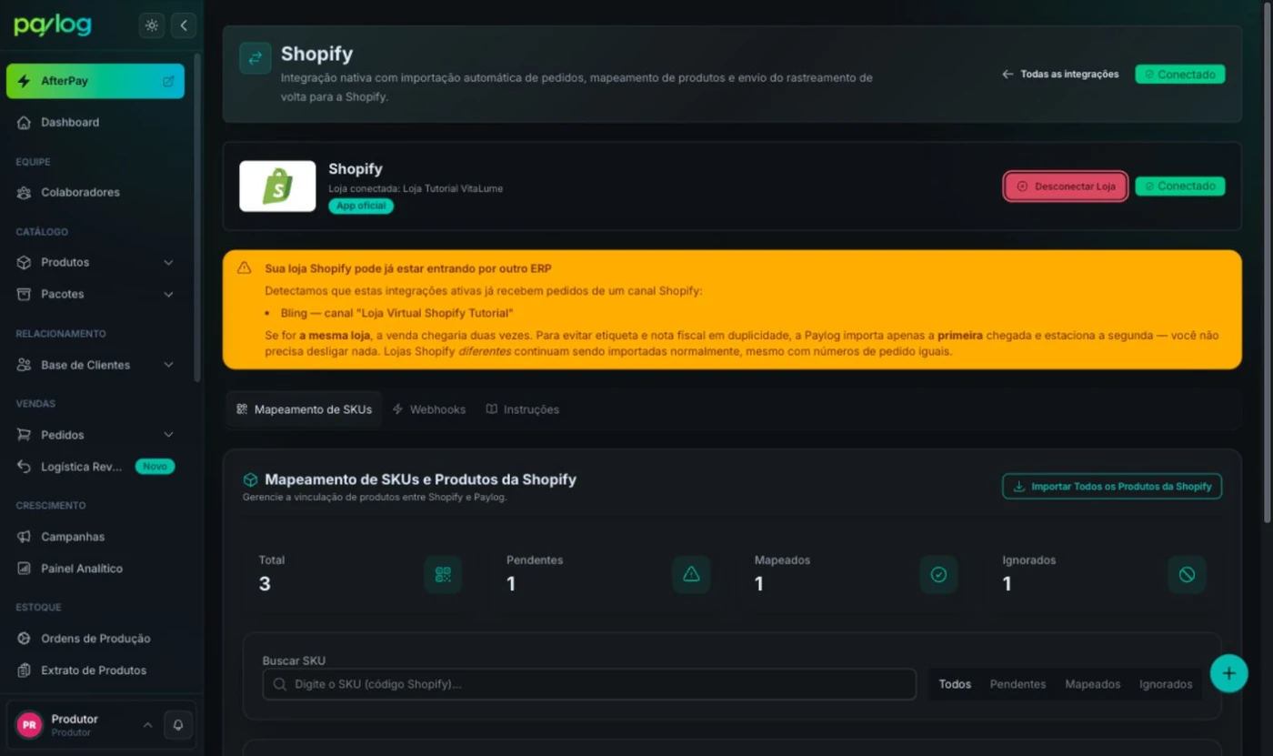 Página da Shopify no Paylog com o botão Desconectar Loja em destaque no cartão da loja conectada, acima do aviso de entrada por outro ERP e das abas Mapeamento de SKUs, Webhooks e Instruções